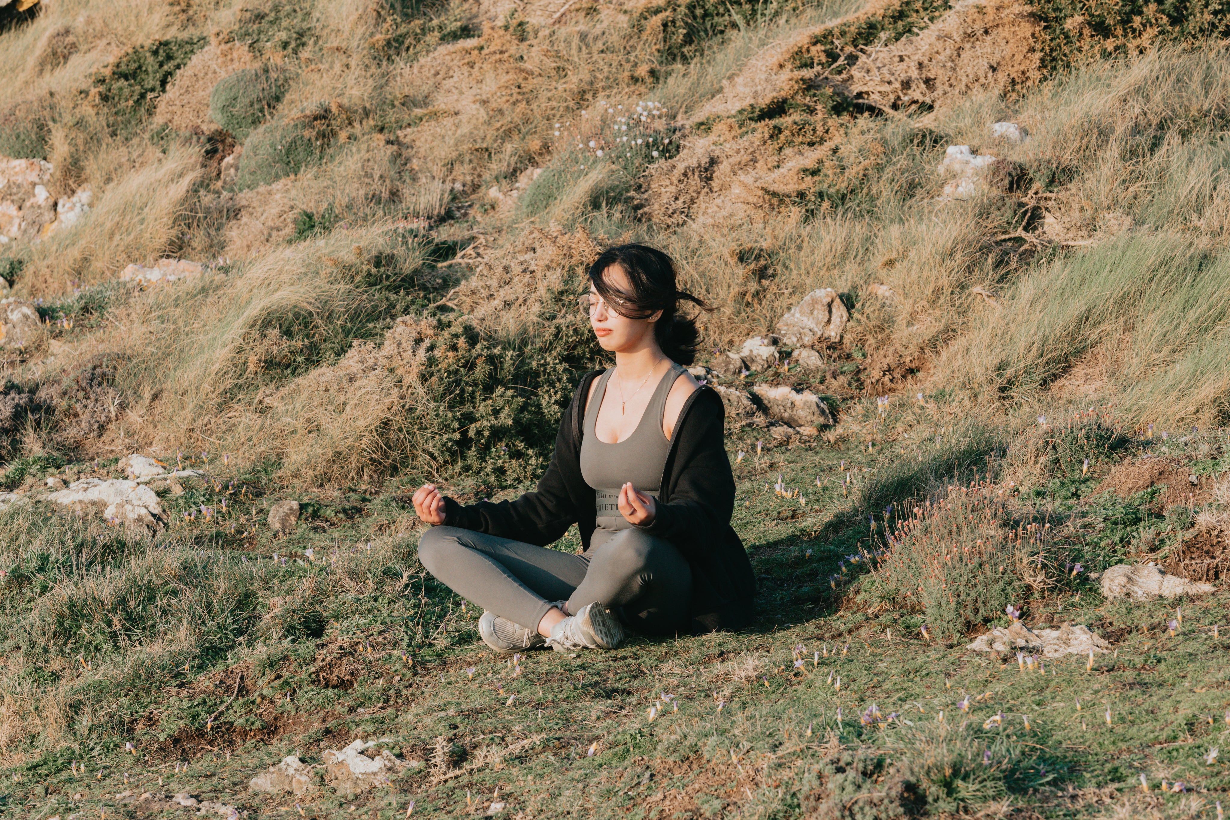 files/woman-meditates-outdoors-on-a-green-grassy-hill.jpg